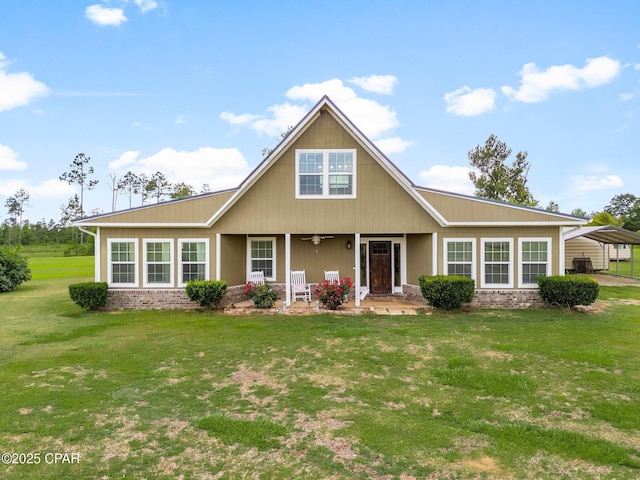 2187 Mayo Rd, Grand Ridge, FL 32442 - view of front of home with covered porch, a front yard, brick siding, and a carport