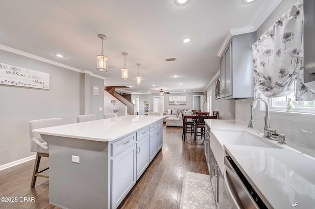 2187 Mayo Rd, Grand Ridge, FL 32442 - kitchen featuring a breakfast bar, recessed lighting, ornamental molding, dark wood-style floors, and open floor plan