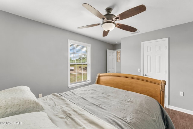 2187 Mayo Rd, Grand Ridge, FL 32442 - bedroom with wood finished floors, baseboards, and ceiling fan