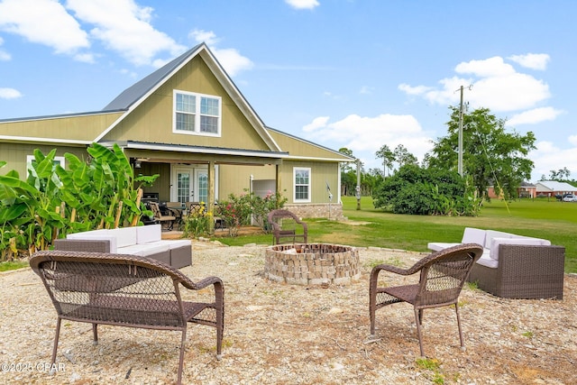2187 Mayo Rd, Grand Ridge, FL 32442 - rear view of house with an outdoor living space with a fire pit, a patio, a lawn, and french doors