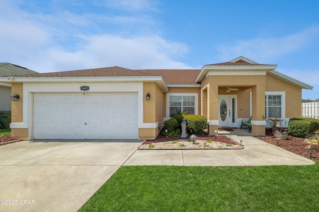 ranch-style house with fence, a garage, driveway, and stucco siding