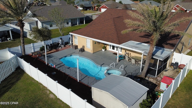 view of pool with a patio, a fenced backyard, a sunroom, and a yard