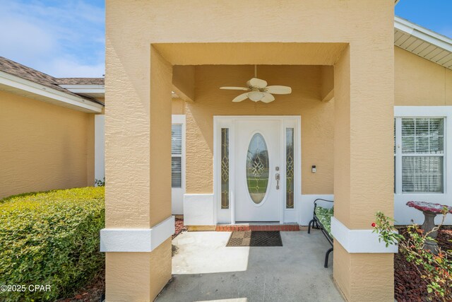 entrance to property featuring stucco siding