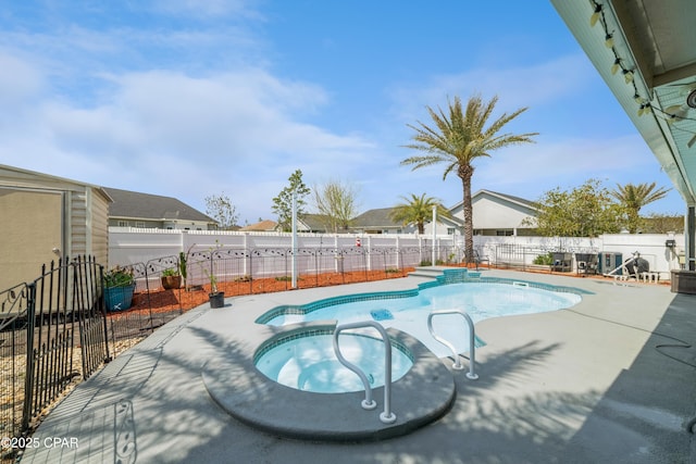 view of pool with a patio, a pool with connected hot tub, and a fenced backyard