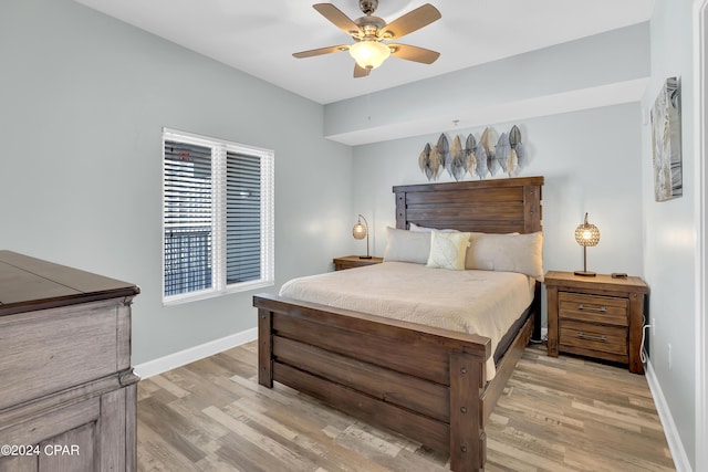 bedroom with baseboards, ceiling fan, and light wood finished floors