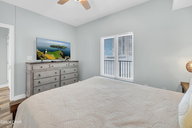 bedroom with baseboards, wood finished floors, and a ceiling fan