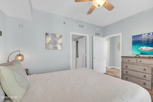 bedroom with wood finished floors, ceiling fan, and visible vents