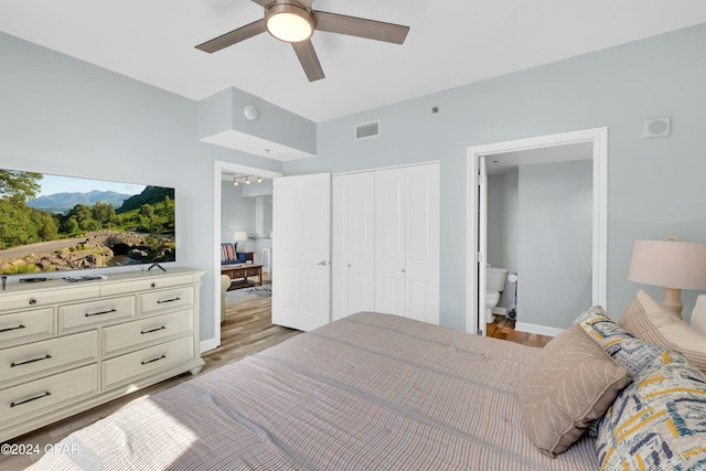 bedroom with a closet, a ceiling fan, light wood finished floors, baseboards, and visible vents