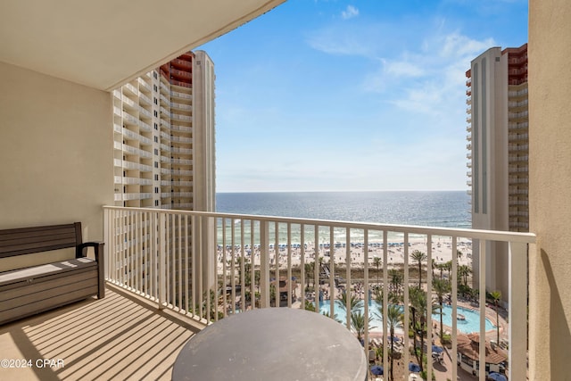 balcony with a beach view and a water view