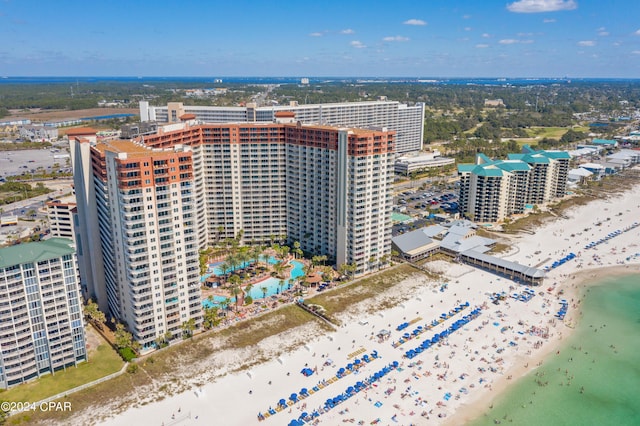 aerial view featuring a water view, a view of the beach, and a city view