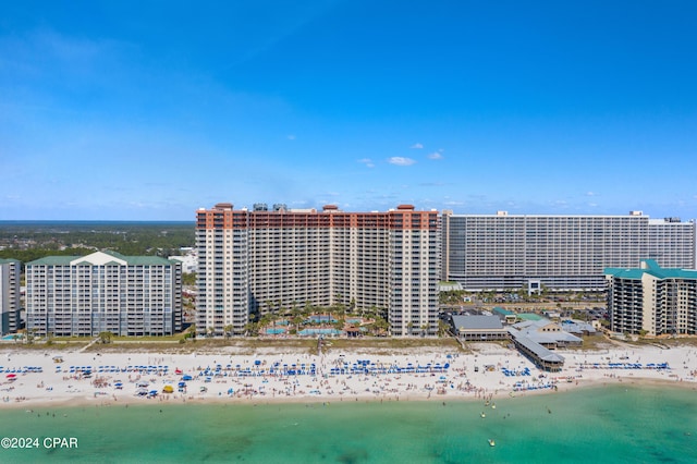 aerial view featuring a water view, a view of city, and a beach view