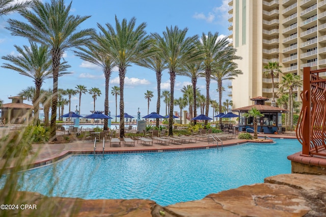 pool with a gazebo and a patio