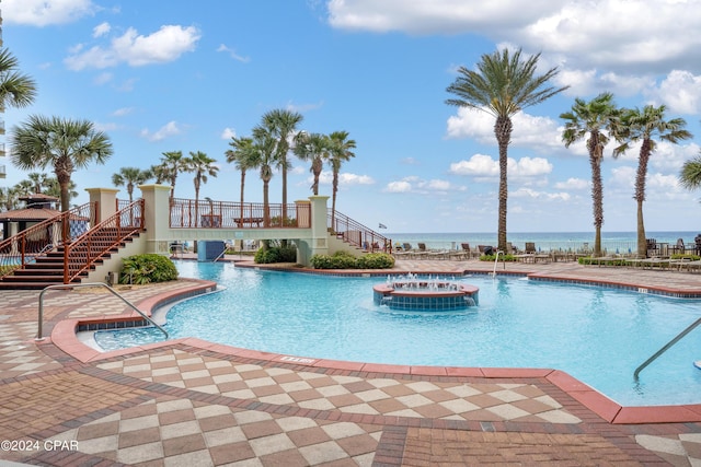 community pool with central AC, stairs, and a patio