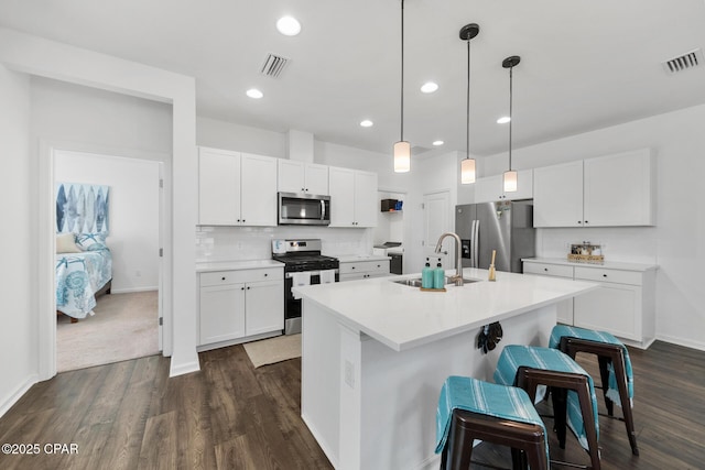 8453 Landshark Blvd, Panama City Beach, FL 32413 - kitchen with tasteful backsplash, visible vents, appliances with stainless steel finishes, light countertops, and a sink
