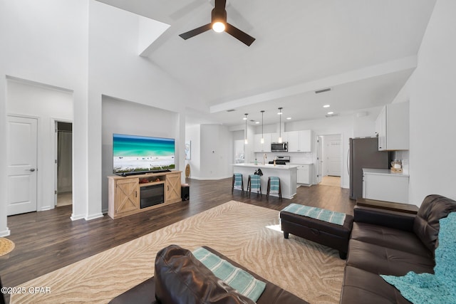 8453 Landshark Blvd, Panama City Beach, FL 32413 - living room featuring dark wood-style flooring, baseboards, recessed lighting, ceiling fan, and high vaulted ceiling