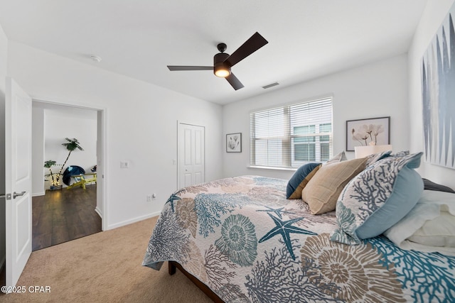 8453 Landshark Blvd, Panama City Beach, FL 32413 - carpeted bedroom with a closet, visible vents, baseboards, and a ceiling fan