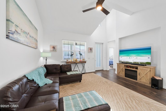 8453 Landshark Blvd, Panama City Beach, FL 32413 - living area with high vaulted ceiling, dark wood-style flooring, ceiling fan, and baseboards