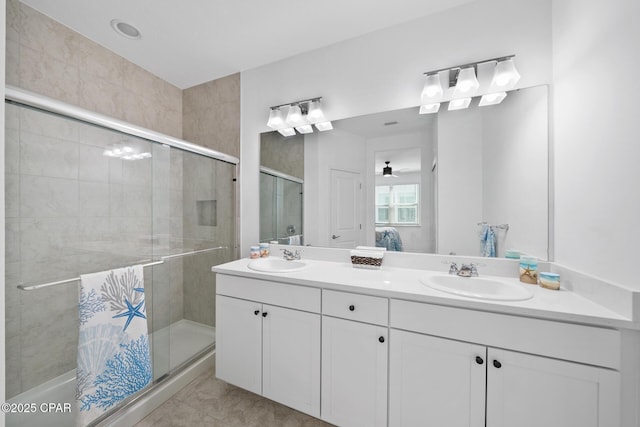 8453 Landshark Blvd, Panama City Beach, FL 32413 - full bathroom featuring a sink, tile patterned floors, double vanity, and a stall shower