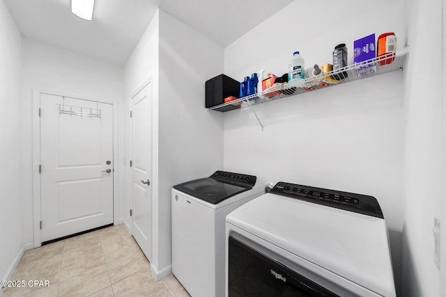 8453 Landshark Blvd, Panama City Beach, FL 32413 - clothes washing area featuring laundry area, washing machine and clothes dryer, baseboards, and light tile patterned floors