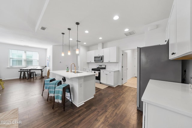 8453 Landshark Blvd, Panama City Beach, FL 32413 - kitchen featuring a sink, visible vents, appliances with stainless steel finishes, and dark wood finished floors