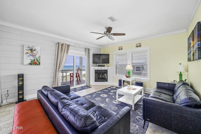 123 Sapodilla Ln, Port St Joe, FL 32456 - living room featuring crown molding, ceiling fan, and a fireplace