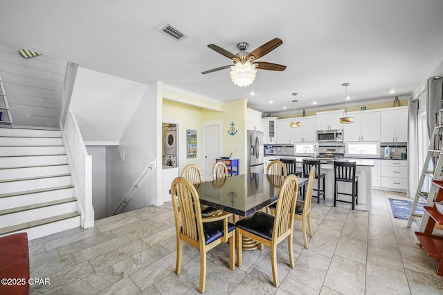 123 Sapodilla Ln, Port St Joe, FL 32456 - dining area with stacked washing machine and dryer, a ceiling fan, recessed lighting, and stairs