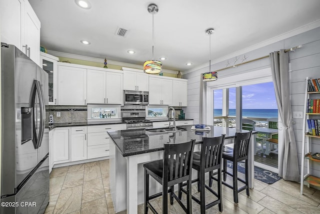 123 Sapodilla Ln, Port St Joe, FL 32456 - kitchen with stainless steel appliances, crown molding, a sink, a water view, and white cabinetry