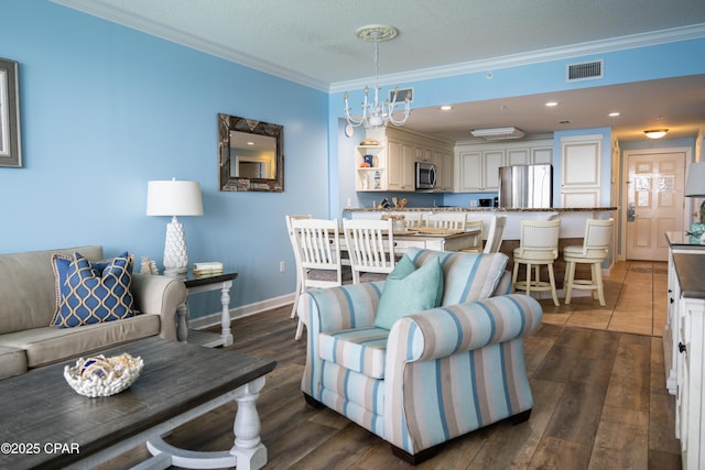 living room featuring ornamental molding, dark wood-style flooring, baseboards, and a textured ceiling