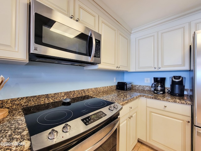 kitchen with stainless steel appliances and light tile patterned floors