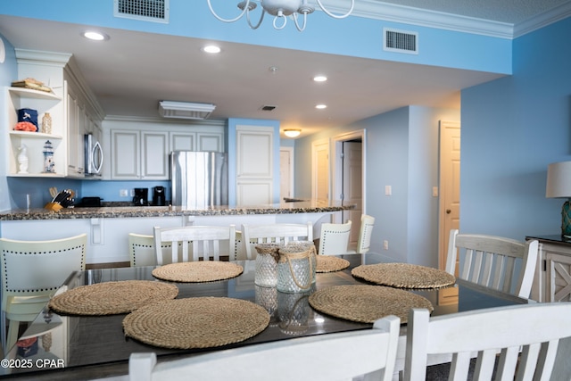 dining room featuring ornamental molding and recessed lighting