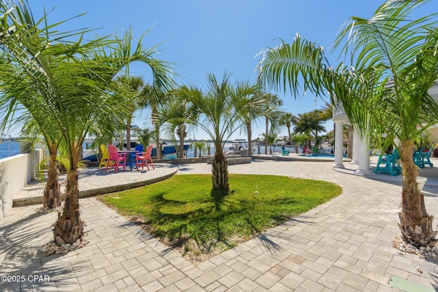 4522 Bay Point Rd, Panama City Beach, FL 32408 - view of home's community with fence, playground community, a swimming pool, a yard, and a patio area