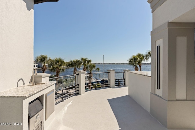 4522 Bay Point Rd, Panama City Beach, FL 32408 - view of patio with a balcony and a water view