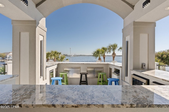 4522 Bay Point Rd, Panama City Beach, FL 32408 - view of patio / terrace with a balcony, a water view, and wine cooler