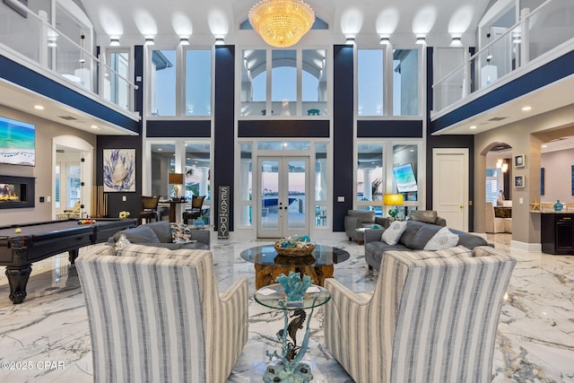 4522 Bay Point Rd, Panama City Beach, FL 32408 - living area featuring marble finish floor, arched walkways, pool table, and a healthy amount of sunlight