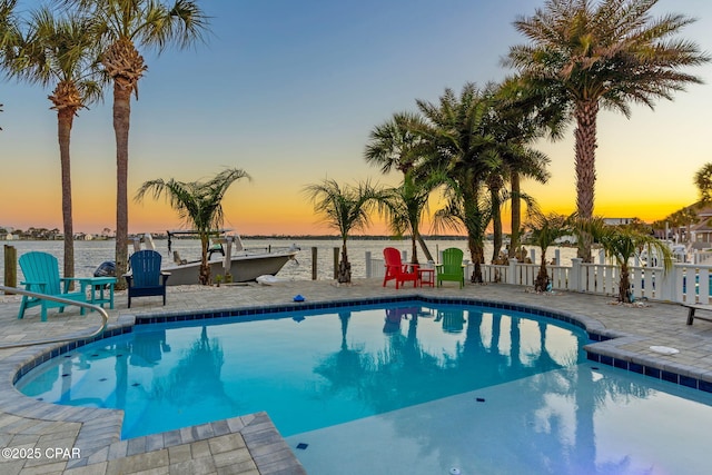 4522 Bay Point Rd, Panama City Beach, FL 32408 - pool featuring a water view, fence, and a patio area
