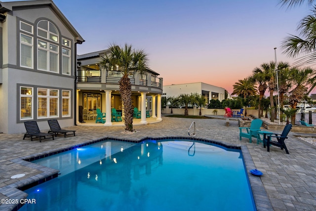 4522 Bay Point Rd, Panama City Beach, FL 32408 - pool at dusk with an outdoor pool and a patio