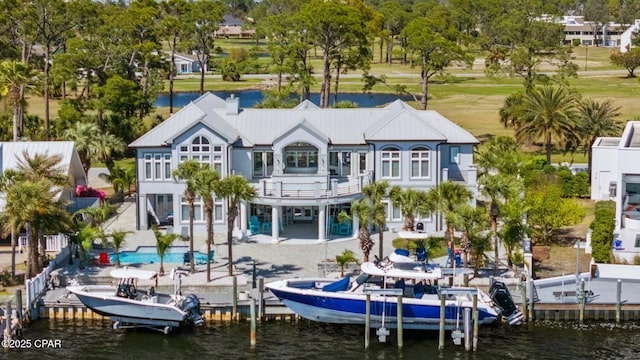 4522 Bay Point Rd, Panama City Beach, FL 32408 - rear view of house featuring boat lift, a balcony, a water view, and a patio