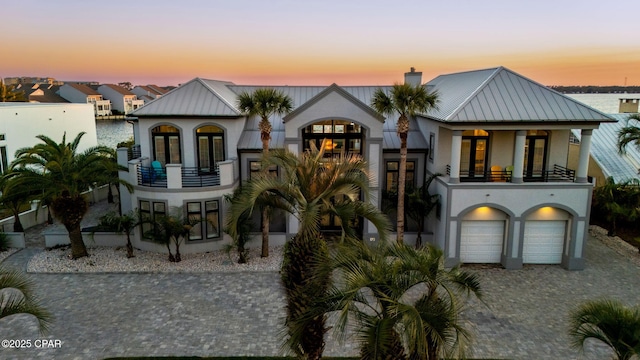 4522 Bay Point Rd, Panama City Beach, FL 32408 - view of front of property with stucco siding, metal roof, and a balcony