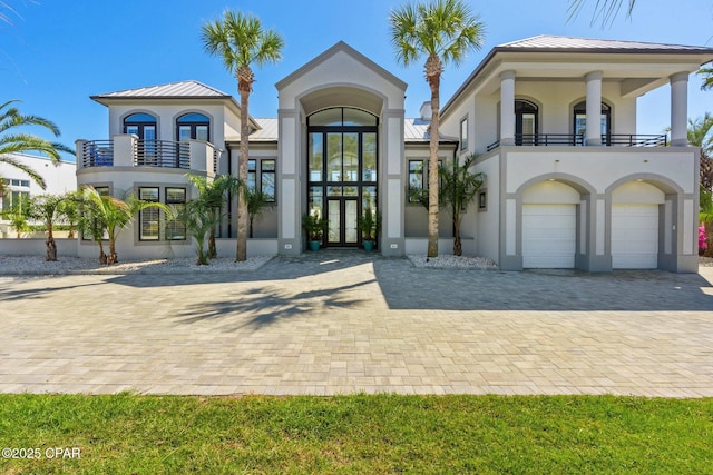 4522 Bay Point Rd, Panama City Beach, FL 32408 - view of front of property featuring a balcony, driveway, stucco siding, and french doors
