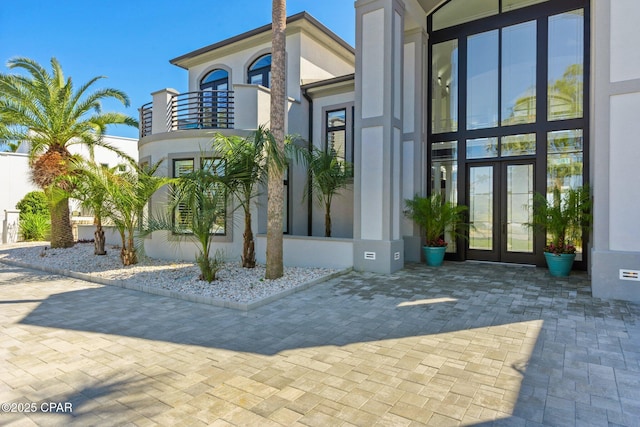 4522 Bay Point Rd, Panama City Beach, FL 32408 - doorway to property featuring stucco siding and french doors
