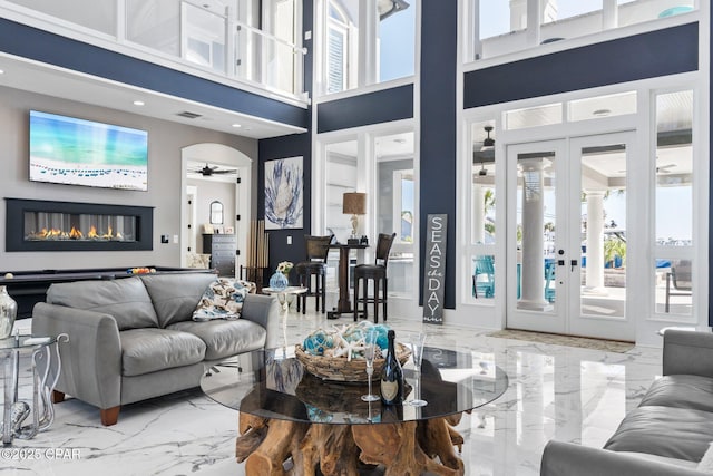 4522 Bay Point Rd, Panama City Beach, FL 32408 - living area with marble finish floor, visible vents, ceiling fan, and a glass covered fireplace