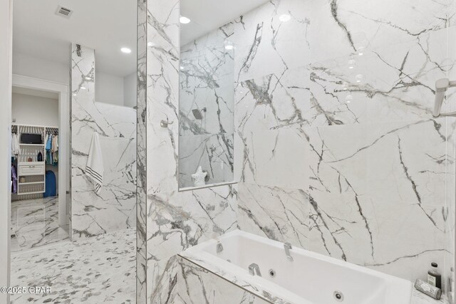 4522 Bay Point Rd, Panama City Beach, FL 32408 - bathroom with visible vents, stone wall, a marble finish shower, a walk in closet, and a whirlpool tub