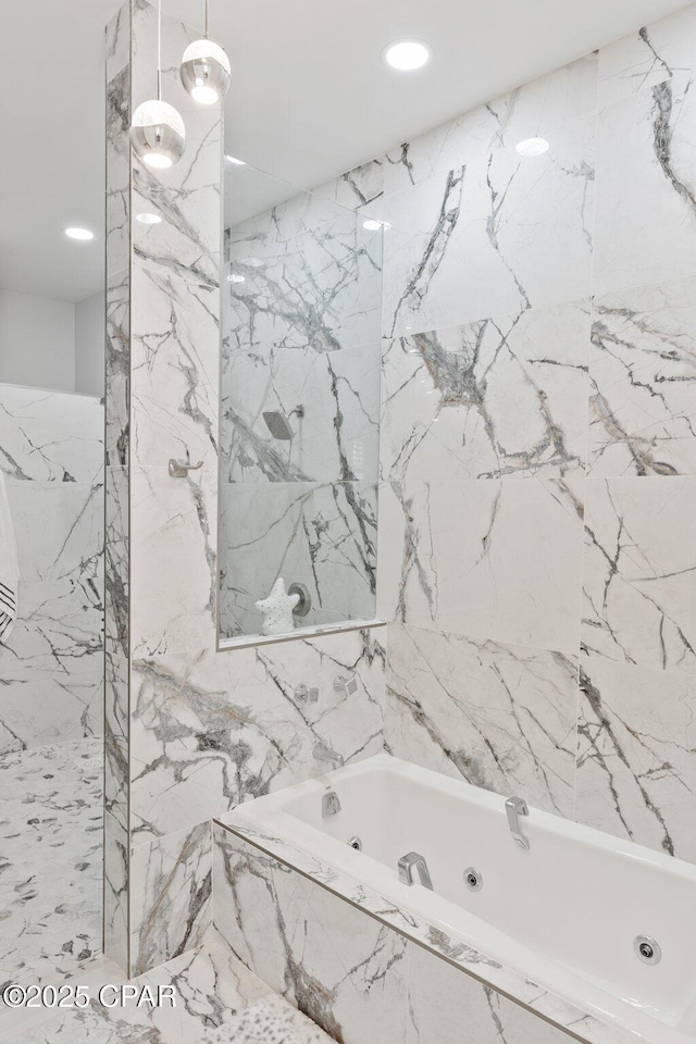 4522 Bay Point Rd, Panama City Beach, FL 32408 - bathroom featuring stone wall, a jetted tub, and a marble finish shower