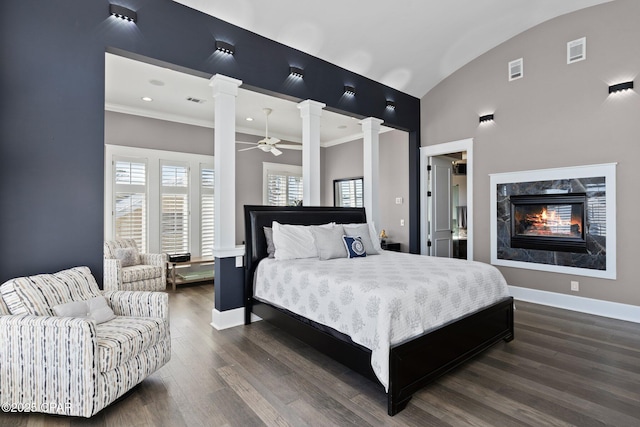 4522 Bay Point Rd, Panama City Beach, FL 32408 - bedroom featuring decorative columns, baseboards, dark wood-style floors, visible vents, and a fireplace