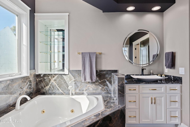 4522 Bay Point Rd, Panama City Beach, FL 32408 - bathroom with a whirlpool tub, vanity, and a wealth of natural light