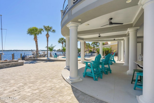 4522 Bay Point Rd, Panama City Beach, FL 32408 - view of patio / terrace with a water view, ceiling fan, and a community pool