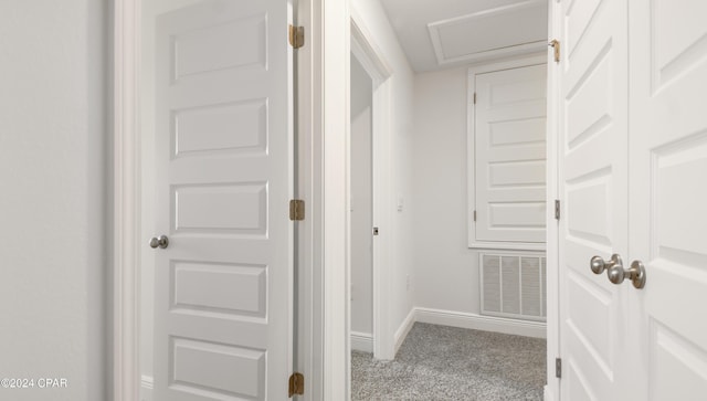 hallway featuring baseboards, carpet, and visible vents
