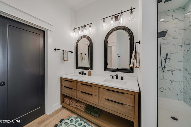 7603 Coastal Hammock Trl, Panama City Beach, FL 32413 - full bath featuring a marble finish shower, double vanity, and wood finished floors