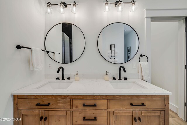 7603 Coastal Hammock Trl, Panama City Beach, FL 32413 - full bathroom with double vanity and wood finished floors
