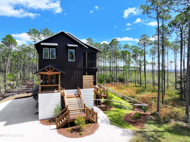 7603 Coastal Hammock Trl, Panama City Beach, FL 32413 - view of front of house featuring stairs and a sunroom